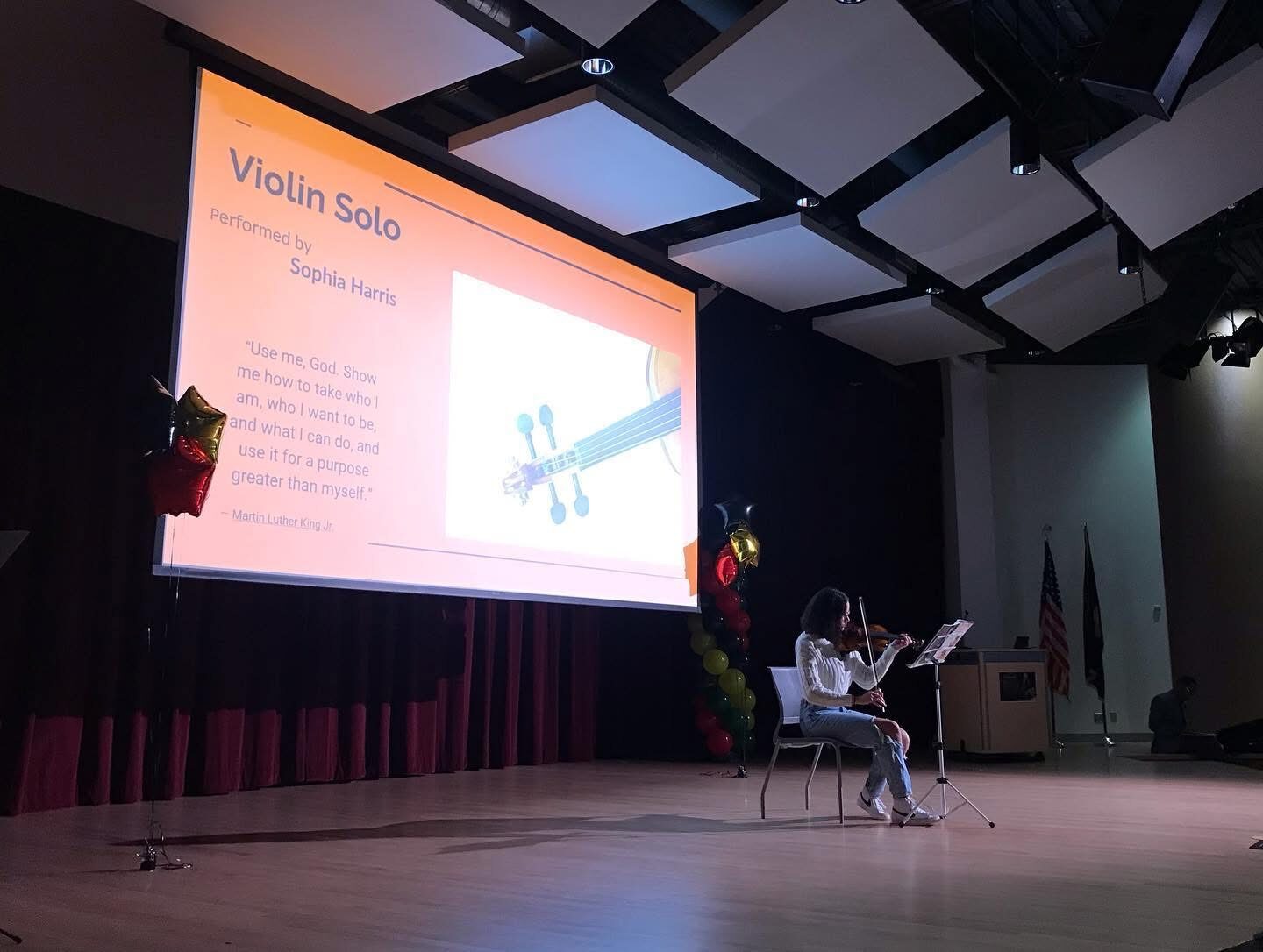 Student performing a violin solo at an MLK Day event