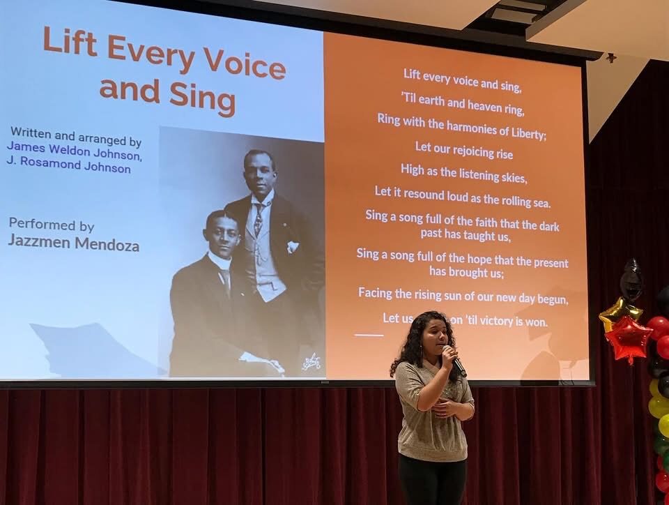 Student performing "Lift Every Voice and Sing" at a youth showcase